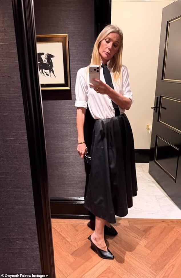She also turned heads in a white shirt with a black tie tucked into a shiny A-line skirt